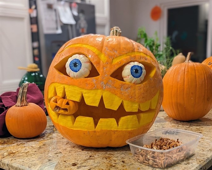 This carver used small gourds for the eyes of this spooky jack-o-lantern. 