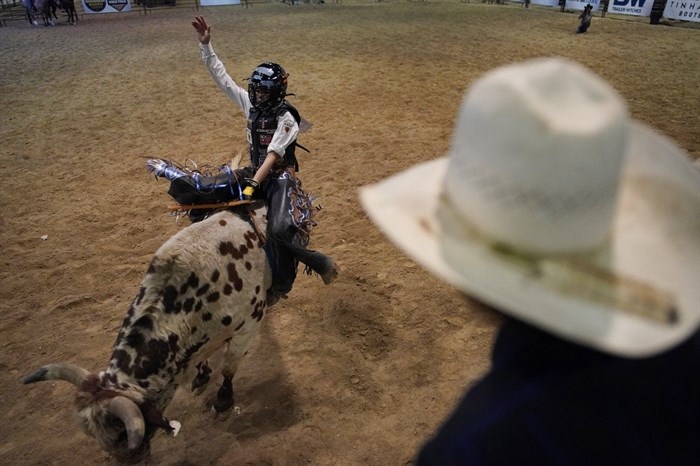 Najiah Knight competes during the Junior World Finals rodeo, Thursday, Dec. 7, 2023, in Las Vegas. Najiah, a high school junior from small-town Oregon, is on a yearslong quest to become the first woman to compete at the top level of the Professional Bull Riders tour. 