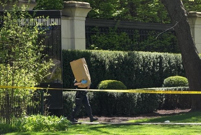 Toronto Police investigate a crime scene outside the mansion of Canadian rap mogul Drake in Toronto's Bridle Path neighbourhood, Tuesday, May 7, 2024. Paramedics said a security guard working outside the home was taken to hospital with serious but non-life-threatening injuries in an overnight shooting. 