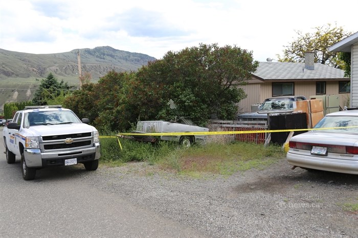 Police tape surrounds a home at 602 Cedar Street in Ashcroft where a body was found June 2, 2014.