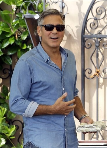 George Clooney walks in the garden of the Cipriani hotel in Venice, Italy, Saturday, Sept. 27, 2014.