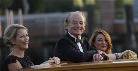 Actor Bill Murray smiles from a boat prior to the George Clooney and Alma Amal Alamuddin wedding in Venice, Italy, Saturday, Sept. 27, 2014.