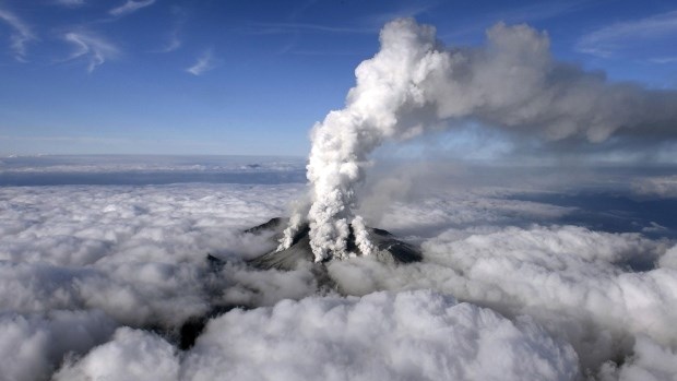 Dense white plumes rise high in the air as Mt. Ontake erupts in central Japan, Saturday, Sept. 27, 2014. (AP / Kyodo News)