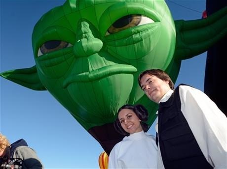 Amber and Nate Hoffman dressed as Princess Leia and Han Solo during the unveiling of the new Yoda balloon at the annual Albuquerque International Balloon Fiesta in Albuquerque, N.M. Saturday, Oct. 4, 2014.