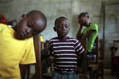Children pray during Sunday service at the Bridgeway Baptist Church in Monrovia, Liberia.