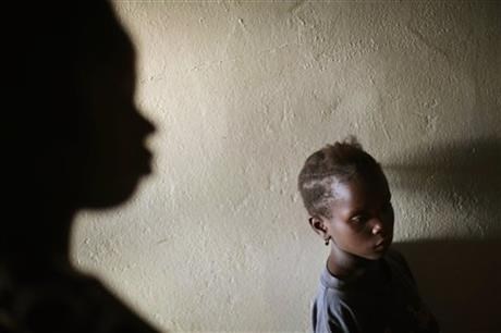 Miamu Saryon, 7, stands in the hallway of Mawah clinic downtown Monrovia, Liberia.