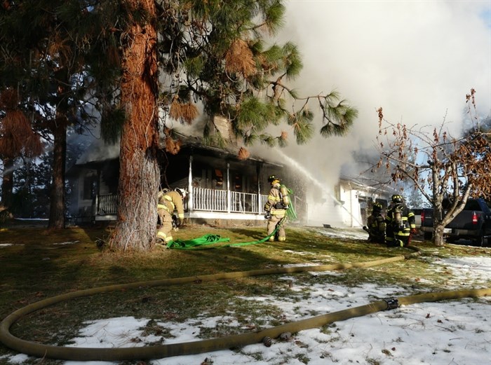 Kelowna firefighters working a house fire at 2642 Monford Road in north Glenmore, Sunday, Nov. 30, 2014.
