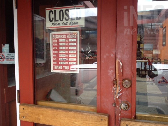 The front doors of the New Delhi restaurant on 29 Street were broken where firefighters forced their way in to fight a fire Dec. 9. 2014. 