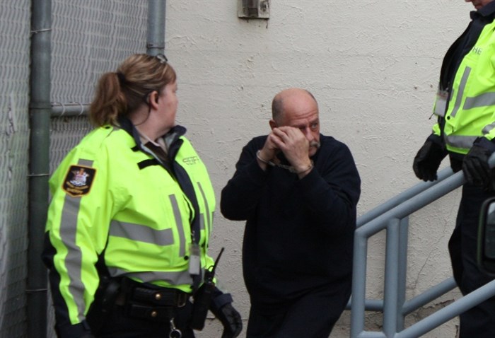 Pier Louis Robotti is led out of Penticton courthouse after a brief appearance Thursday.
