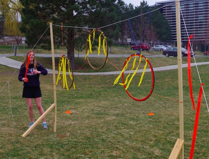 Player Katie Bieber sets up the bike tire hoops on the makeshift quidditch field