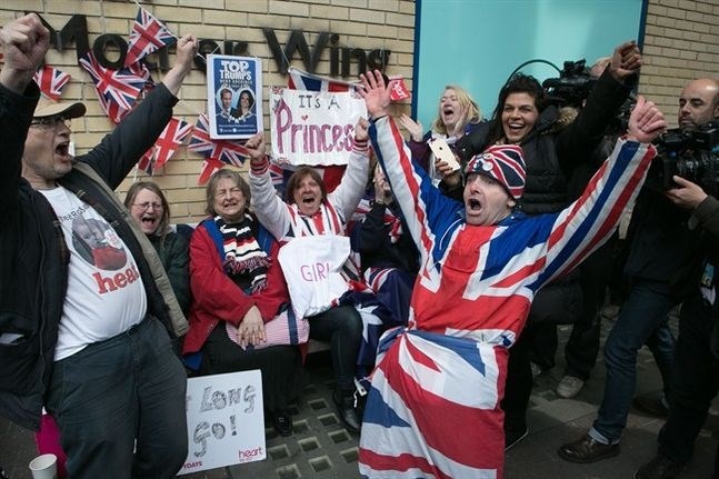 Royal fans and well wishers react after Kensington Palace announced that Kate, the Duchess of Cambridge, had given birth to a girl, outside the Lindo Wing of St. Mary's Hospital, London, Saturday, May 2, 2015. Kensington Palace said in a brief statement that Prince William's wife 