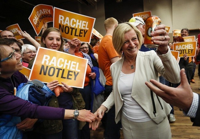 Alberta NDP Leader Rachel Notley holds a can of orange Crush soda pop as she enters a campaign rally in Calgary, Alta., Saturday, May 2, 2015. 