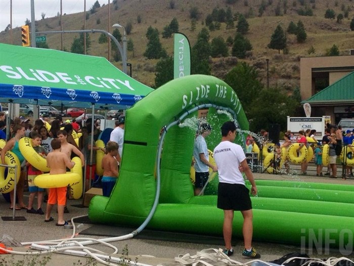 Slide the City set up a 1000-foot slip and slip on Hillside Drive in Kamloops, Saturday, July 18, 2015.