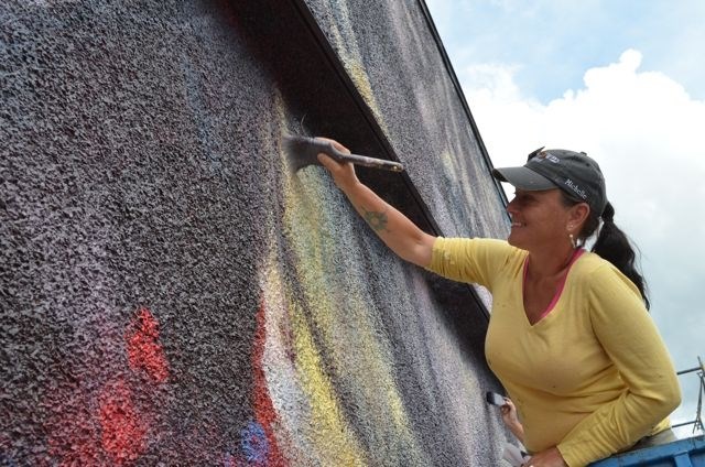 Michelle Loughery works on a new mural in Vernon. (FILE PHOTO)