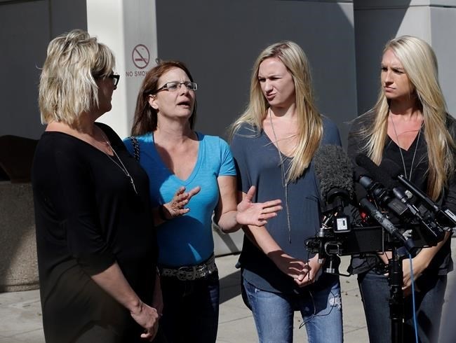 Bonnie Schaan, second from left, discuss her daughter, Cheyeanne Fitzgerald, who was wounded in the shooting at Umpqua Community College, during a news conference outside Mercy Medical Center, Saturday, Oct. 3, 2015, in Roseburg, Ore. Cheyeanne Fitzgerald, 16, is listed in critical condition from a gunshot wound that required the removal of her kidney.