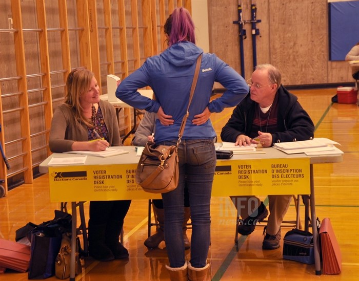 Nikki Newlove gets registered to vote before casting her ballot in West Kelowna.