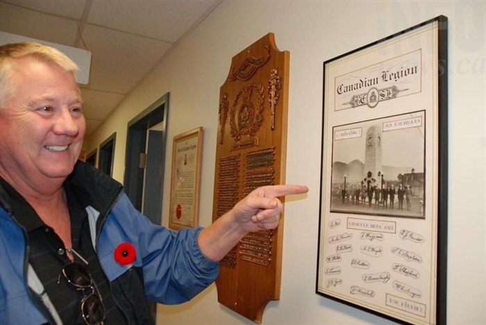Craig Thomson points to the Legion 52's founding members.