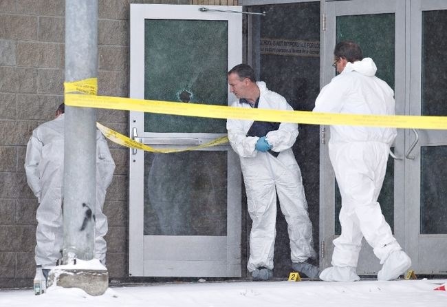 Police investigate the scene on Saturday, January 23, 2016 of a Friday shooting at a school in La Loche Sask. The shooting left four people dead.