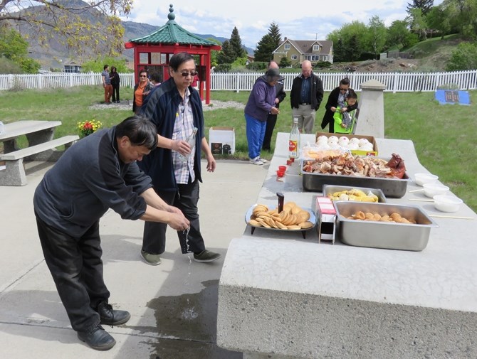 Wine being offered at the 2015 Ching Ming ceremony at the Kamloops Chinese cemetery.
