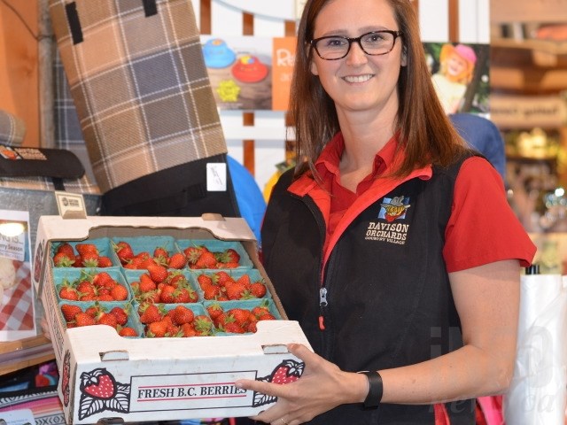 Leah Campbell with a flat of fresh, local strawberries from their farm in the North Okanagan. 
