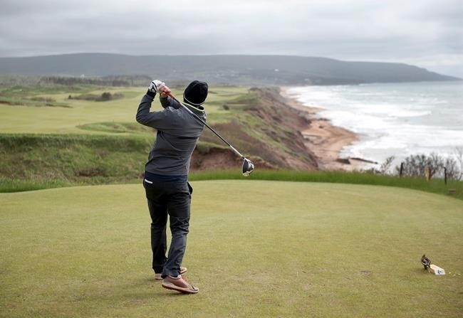 A golfer hits from the tee on the 528 yard, par 5, 18th hole at Cabot Cliffs, the seaside links golf course rated the 19th finest course in the world by Golf Digest, is seen in Inverness, N.S. on Wednesday, June 1, 2016. 