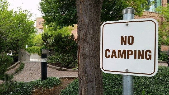 One of the new 'no camping' signs outside the Kelowna Courthouse. 