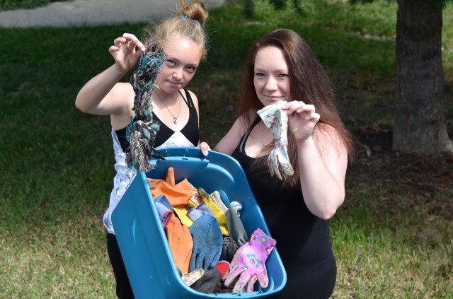 Cindy Schmidt and her daughter Shakira with some of the gloves and dog toys their cat Sketch dragged home. 