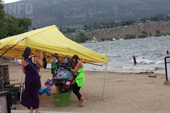 A brief wind and rain storm disrupted vendor's activities near the Peach Concession on Okanagan Lake Beach on Canada Day, Friday, July 1, 2016.

