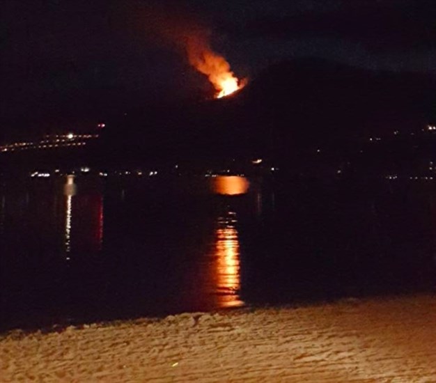 A fire burns above Adventure Bay July 30, 2016. 