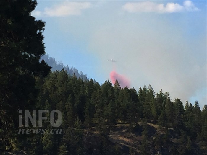 An air tanker drops a load of retardant on a wildfire burning just north of Lake Okanagan Resort on the west side of Okanagan Lake, Wednesday, Aug. 17, 2016.