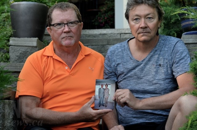 Scott and Paul May with a photo of their parents. Their father, Bill May, was killed by his roommate at a care home for patients with complex behavioural issues. 