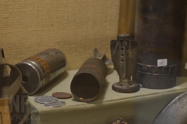 The centre artifact is a military shell that was inspected, deemed safe and allowed to stay on display. 