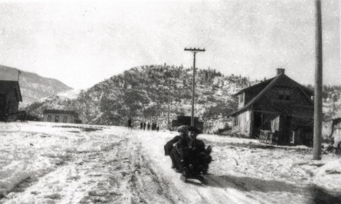 Children sledding down School Avenue in Oliver, including the B.C. Provincial Police Station (now the Oliver Museum) on the righthand side.