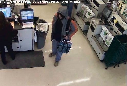 This still image shows the suspect holding the alleged stolen purse. 