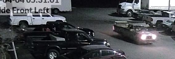 The stolen truck is seen in the top left hand corner and the Mazda is seen with headlights on and driving in the bottom right corner of this surveillance still released by Central Okanagan Crime Stoppers. 