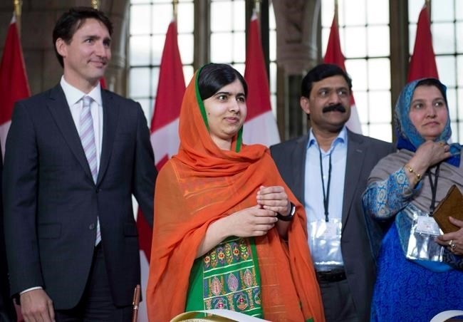 Malala Yousafzai stands with Prime Minister Justin Trudeau and her parents after arriving on Parliament Hill for her Honorary Canadian Citizenship ceremony in Ottawa on Wednesday, April 12, 2017. 