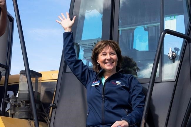 B.C. Liberal Leader Christy Clark waves to supporters from a front-end loader during a campaign stop at Kentron Construction, in Kitimat, B.C. on Thursday, April 13, 2017.