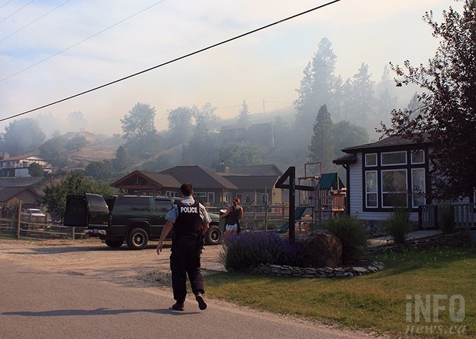RCMP issue evacuation notices to residents on Ponderosa Drive in Kaleden at the height of yesterday's wildfire.