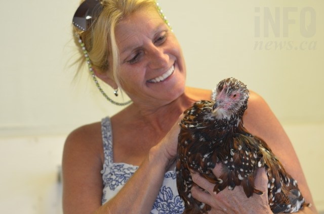Gena Sandli with one of the chickens they picked up from the Paxton Valley. 