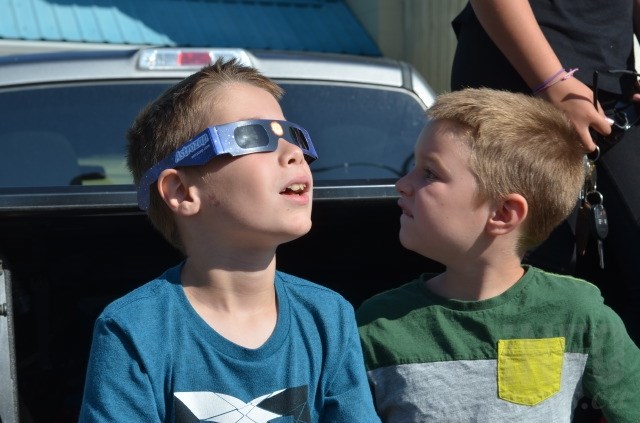 Nathan Anderson, 9, watches in awe as the moon passes in front of the sun. 