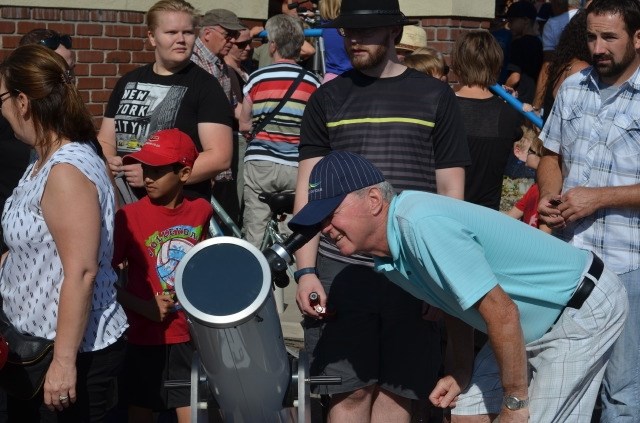 Blake Hanna takes an opportunity to view the eclipse through a telescope. 