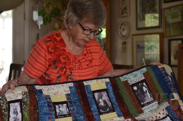 Helen Brandt with a quilt she made featuring old family photos. 