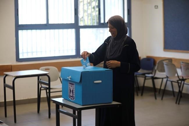 A woman votes in Jerusalem Tuesday, Sept. 17, 2019. Israelis began voting Tuesday in an unprecedented repeat election that will decide whether longtime Prime Minister Benjamin Netanyahu stays in power despite a looming indictment on corruption charges.