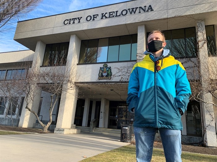 Reuben Scott, from Summerland who commutes to Kelowna for school, observes an anti-COVID-19 restriction protest in Stuart Park, Saturday, Jan. 23, 2021.