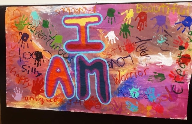 This poster was created by Rae Bennett's students in school district 73 in Kamloops. Students painted positive words about themselves around the title 