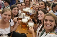 FILE - Women with glasses of beer pose for a photo on day one of the 188th &#39;Oktoberfest&#39; beer festival in Munich, Germany, Saturday, Sept. 16, 2023. The southern German state of Bavaria will ban the smoking of cannabis at public festivals, inside beer gardens, and even at the world’s most popular beer festival, the Oktoberfest. 