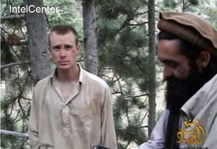 This file image provided by IntelCenter on Dec. 8, 2010, shows a frame grab from a video released by the Taliban containing footage of a man believed to be Bowe Bergdahl, left.