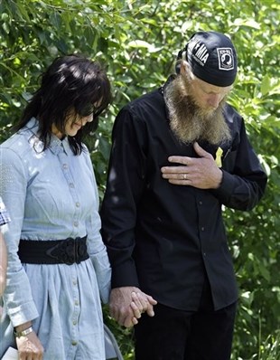 Bob Bergdahl, right, and Jani Bergdahl, the parents of U.S. Army Sgt. Bowe Bergdahl, pray at the 