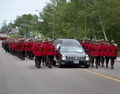 The funeral procession for the three RCMP officers who were killed in the line of duty, makes its way to the regimental funeral at the Moncton Coliseum on Tuesday, June 10, 2014.