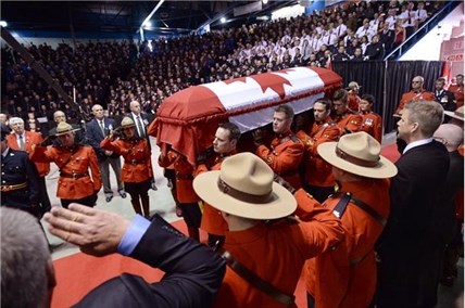 The casket of Const. Douglas James Larche, is carried into the Moncton Coliseum for the RCMP regimental funeral on Tuesday, June 10, 2014, in Moncton, N.B. 
